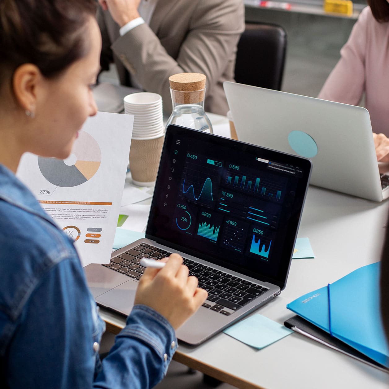 woman working on laptop showing ai generated stats