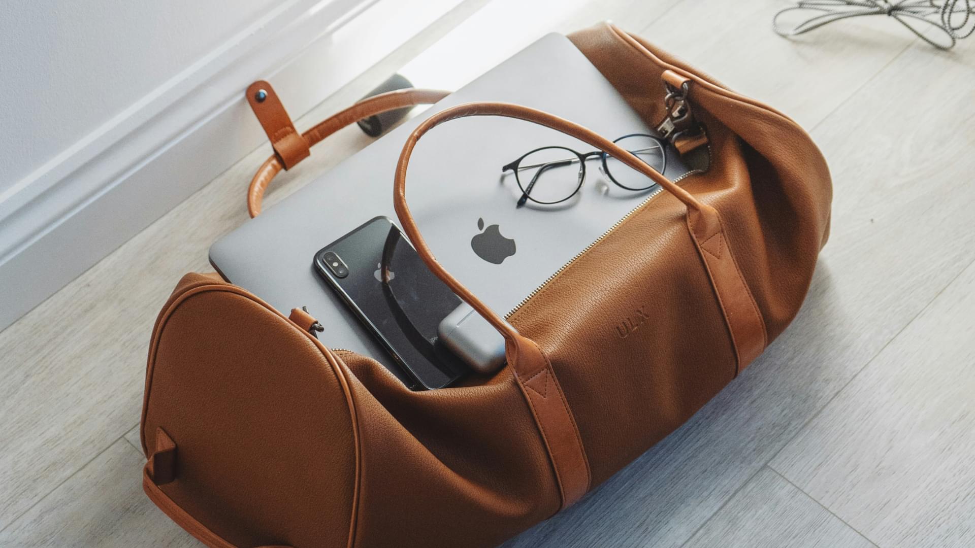 apple products in leather bag