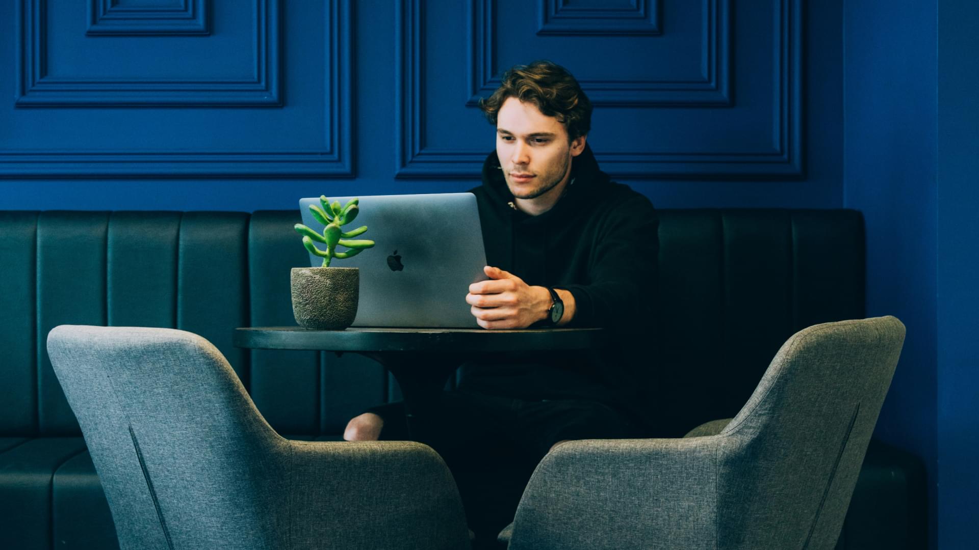 man on laptop minimal room