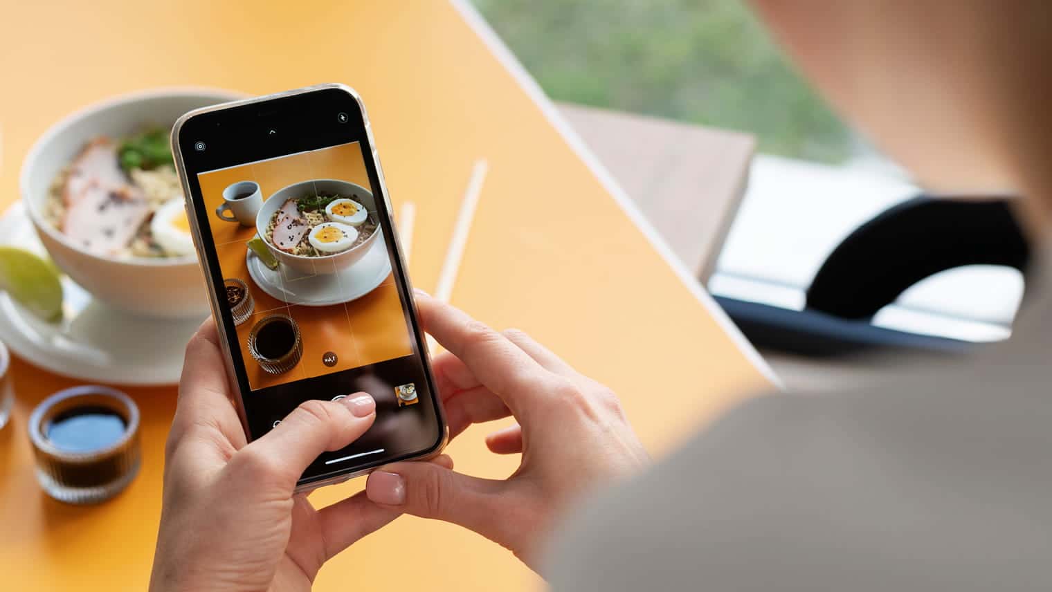 Content creator taking photo of food on phone
