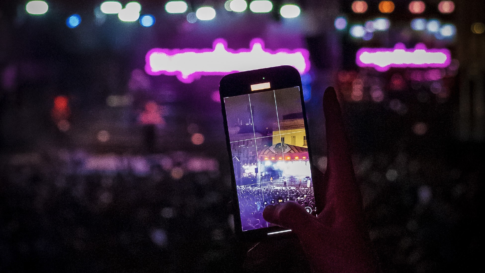 Phone taking picture as busy festival