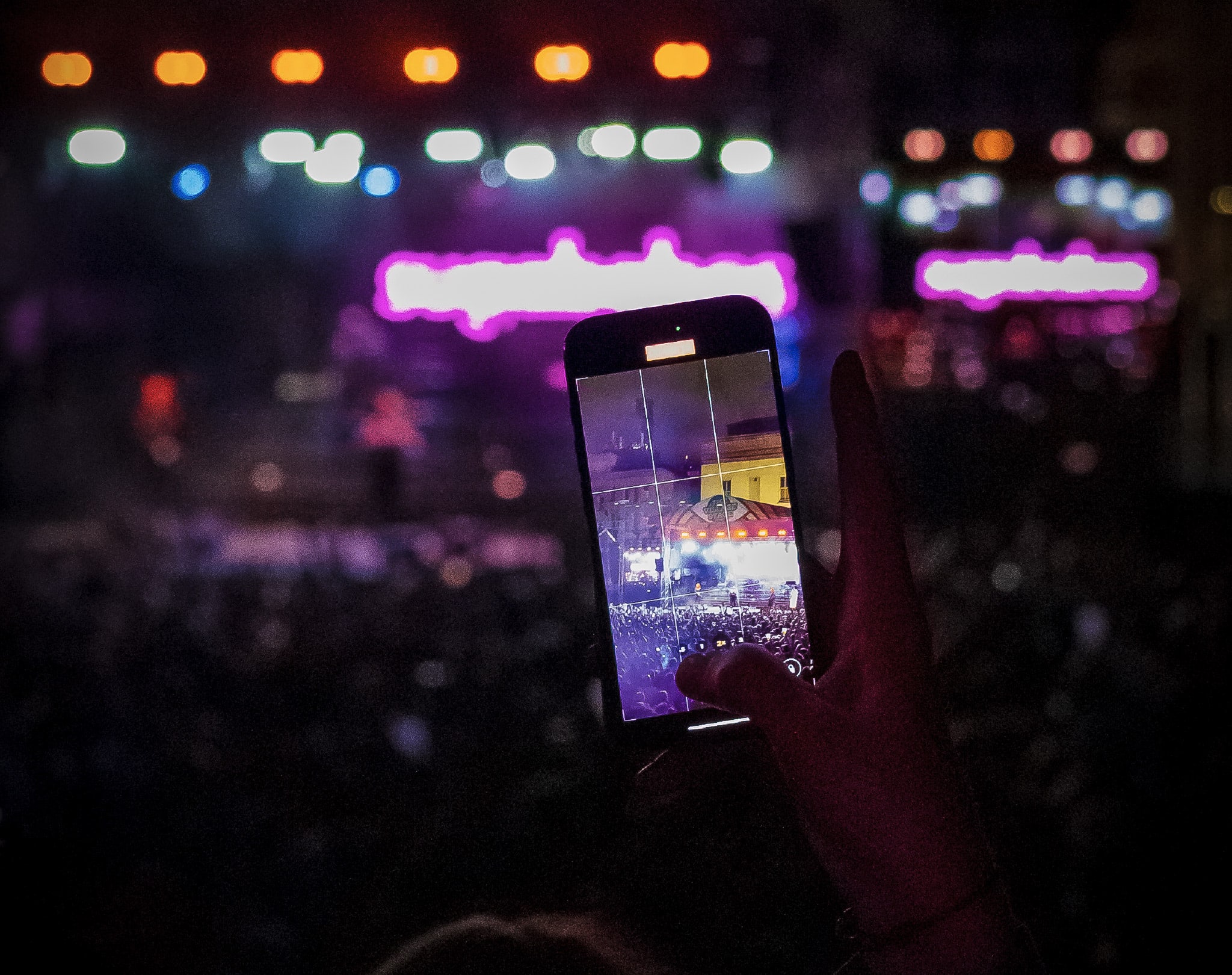 Phone taking picture as busy festival