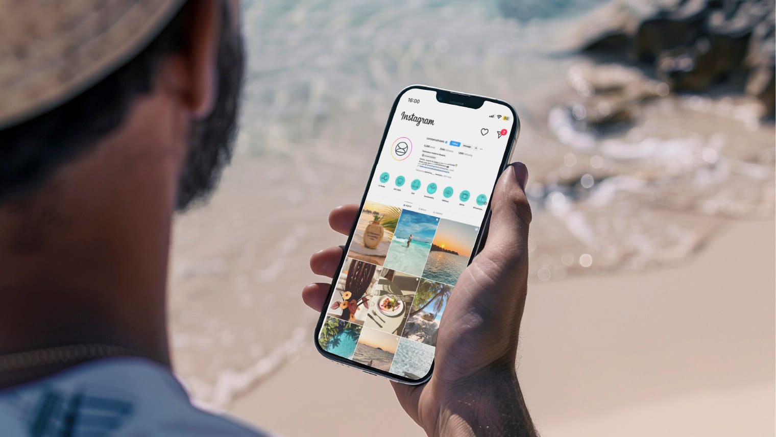 man on beach looking at phone