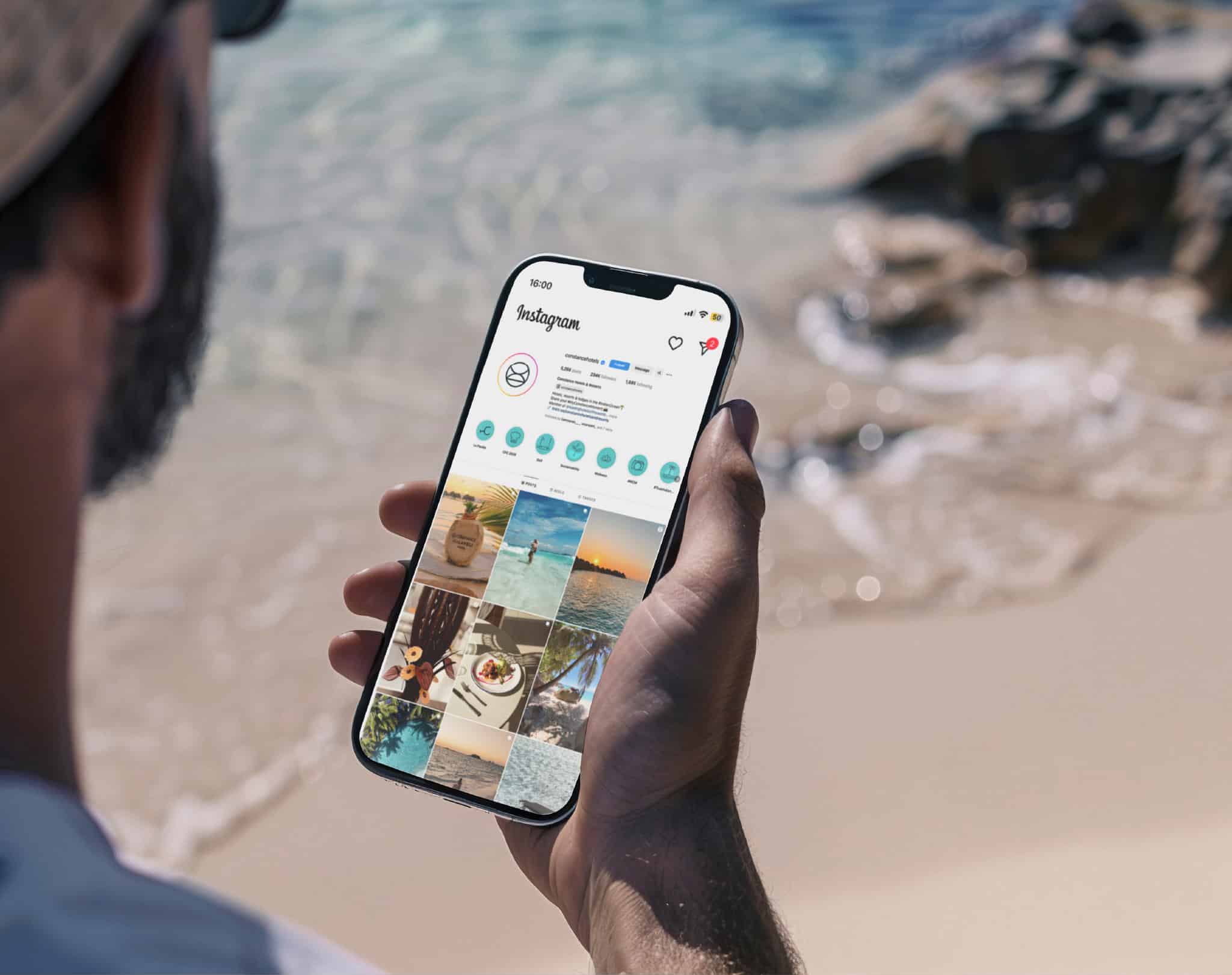 Man on beach looking at phone