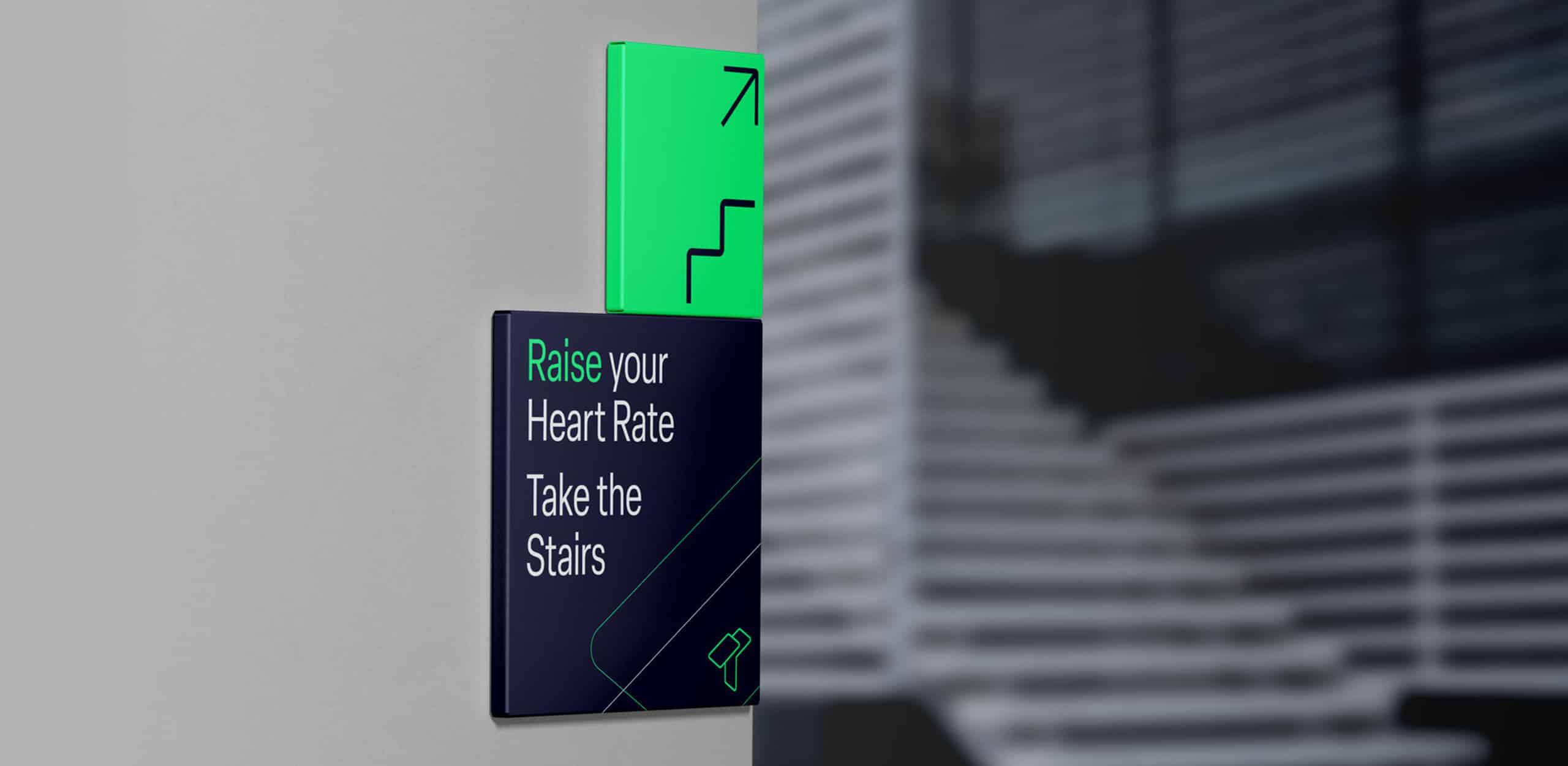 Mock up of stair sign saying Raise your heart rate and take the stairs