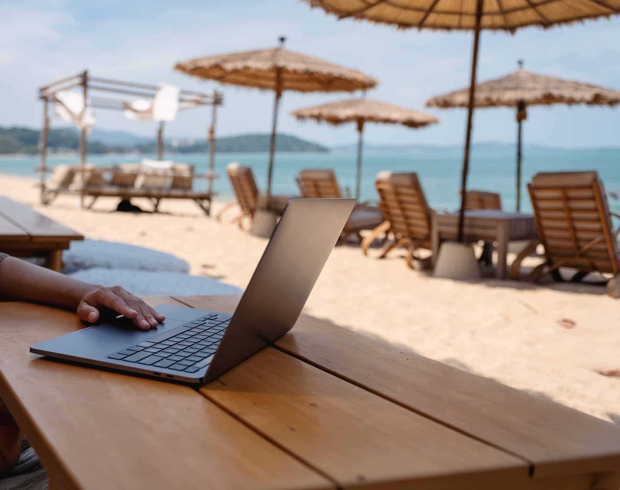 Working on laptop on beach